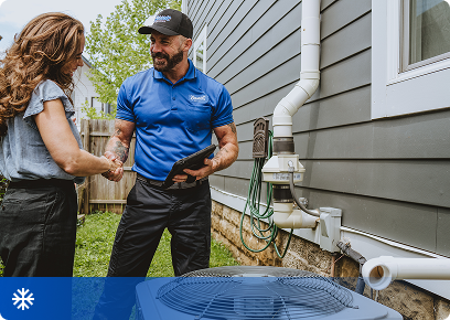 Bassett Services technician talking with a homeowner beside her outdoor AC unit