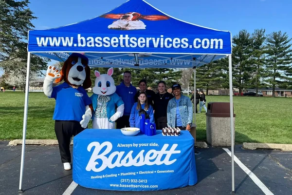 Bassett Services team with the hound mascot and the Easter Bunny at the Bassett tent during an Easter egg hunt