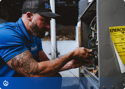Bassett Services technician repairing the wiring inside a furnace
