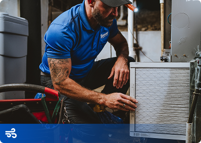 Bassett Services technician replacing a furnace air filter