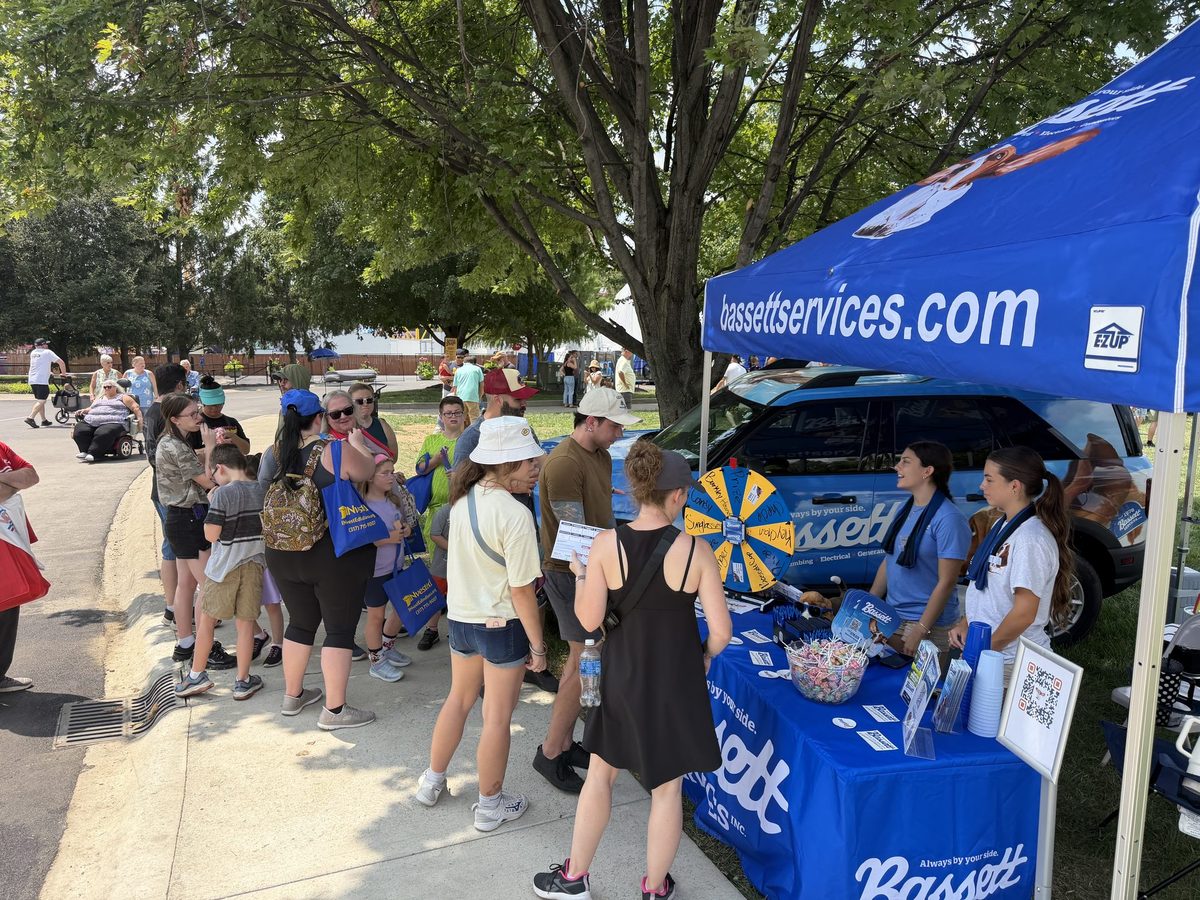Bassett Services booth with visitors at the Indiana State Fair