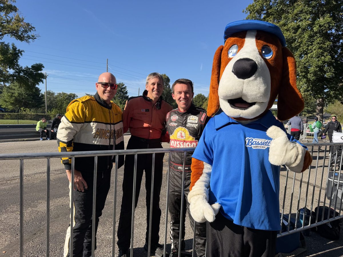 Bassett Services mascot with race car drivers at the Race of Champions